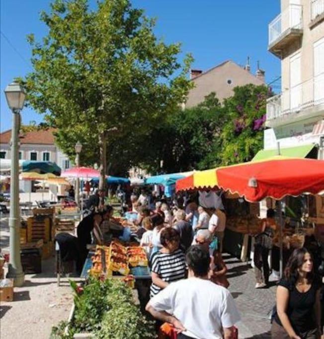 a group of people standing at an outdoor market at Les Jardins de Provence • Beau Rivage • Proche mer in Carqueiranne