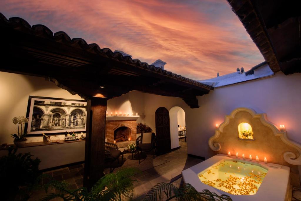 a house with a pool in the middle of a patio at Villa Las Mil Flores in Antigua Guatemala