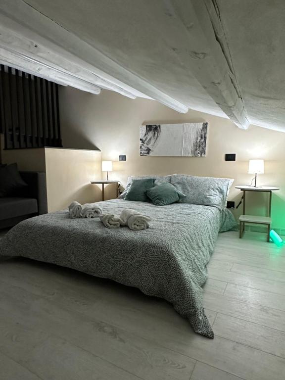 a bedroom with a large bed with two lamps at Olinad rooms in Castelbuono