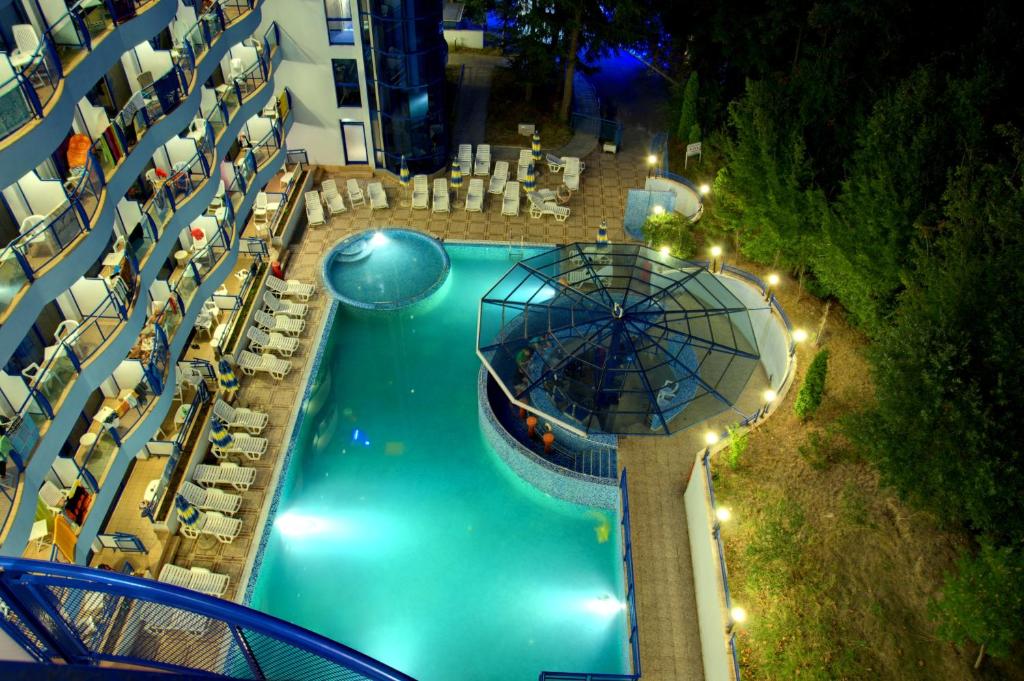 an aerial view of a pool at a resort at night at Aphrodite Hotel in Golden Sands