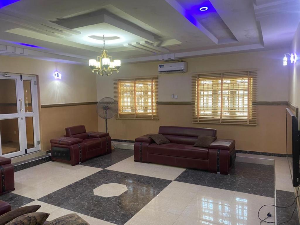 a living room with two couches and a television at S&Y Apartment in Ilesa