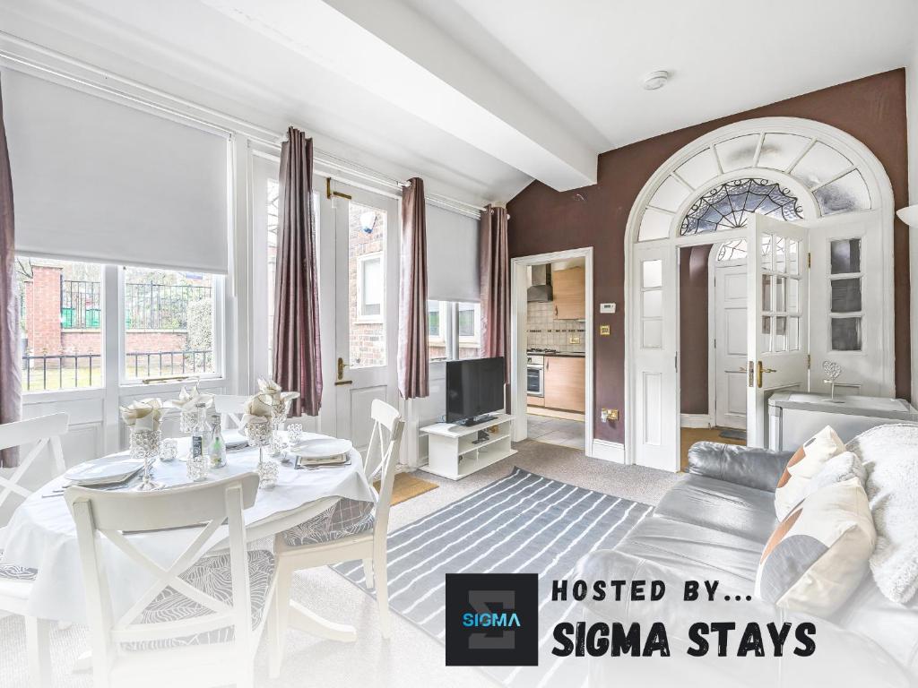 a living room with a couch and a table at Grove House - By Sigma Stays in Newcastle under Lyme