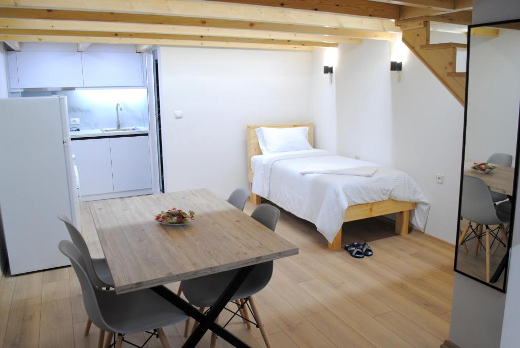 a bedroom with a bed and a table and a table and chairs at Guest House Dashi in Gjirokastër
