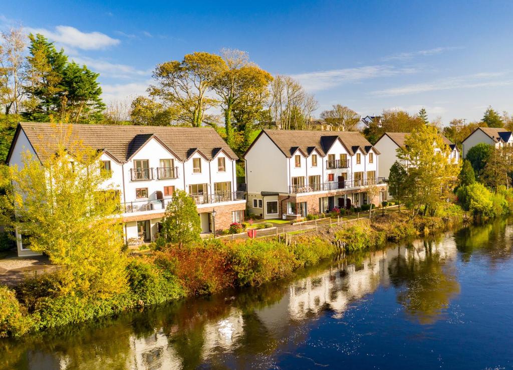 a row of houses next to a river at Grove Lodge No 8 2 Bed in Killorglin