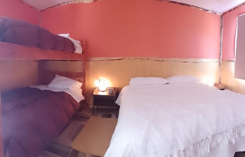 Voodi või voodid majutusasutuse Cabañas & Hostal Lefuco toas