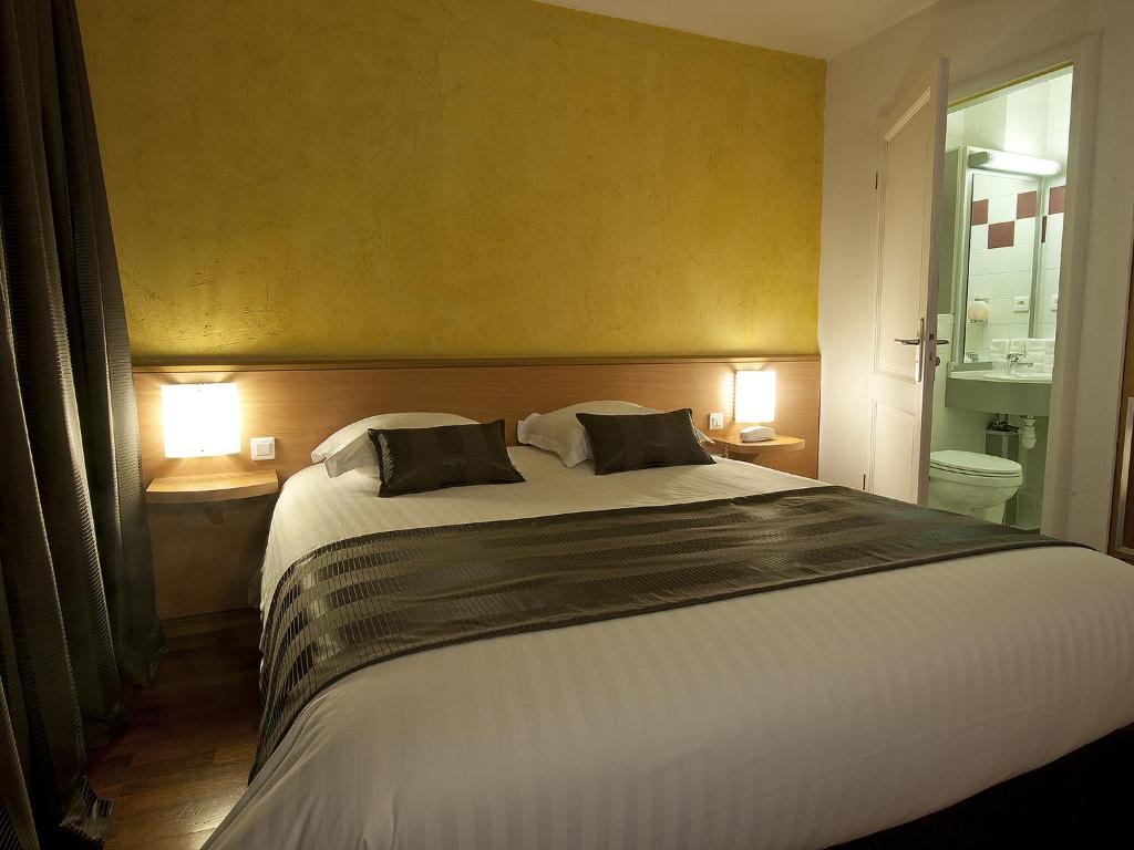 Postel nebo postele na pokoji v ubytování Hôtel le Grillon