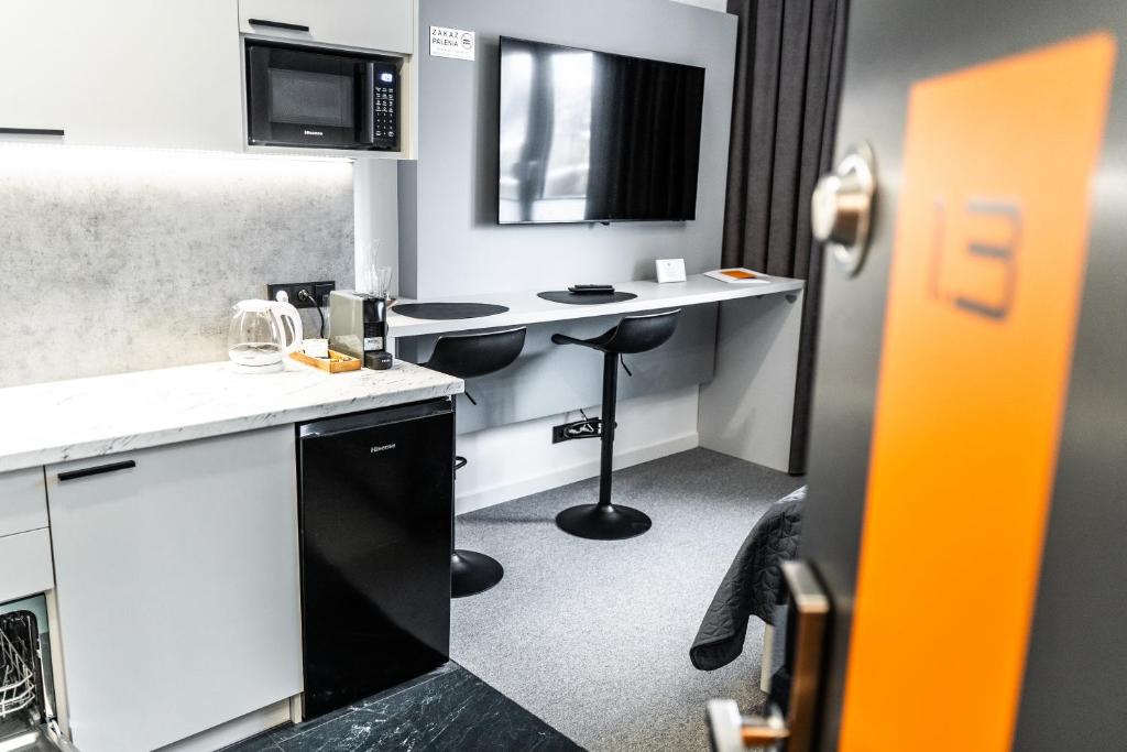 TV a/nebo společenská místnost v ubytování K20 Apartamenty Łódź - Dostęp na Kod