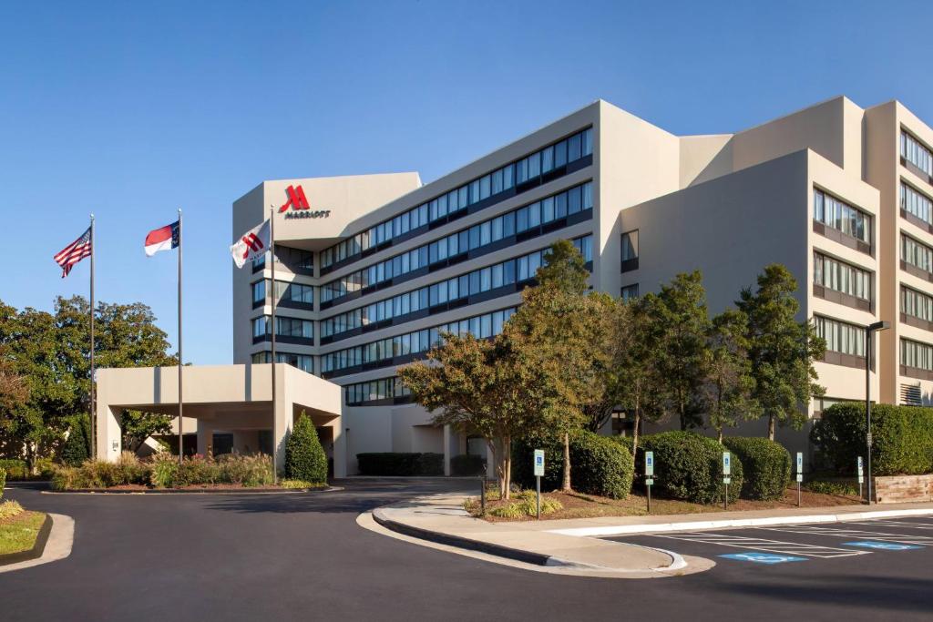 an office building with flags in front of it at Marriott Raleigh Durham Research Triangle Park in Durham