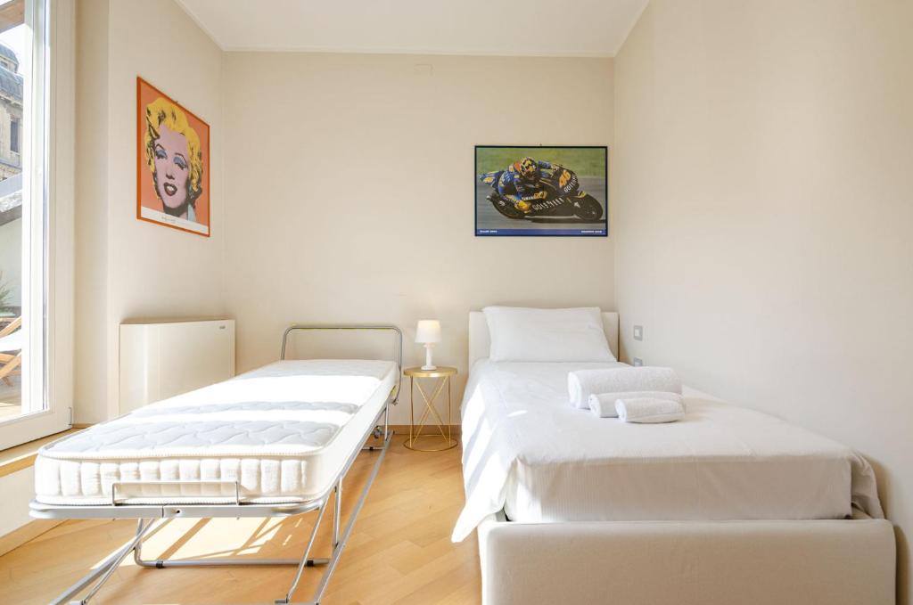 A bed or beds in a room at Rizzoli Terrace Apartment