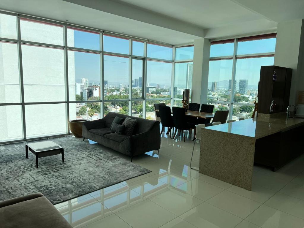 a living room with a couch and a table at Penthouse Minerva in Guadalajara