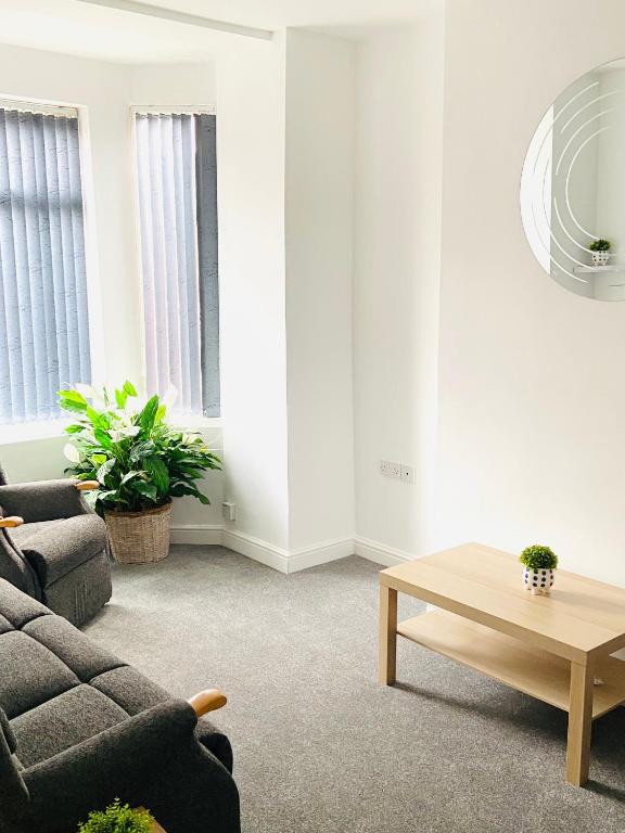 a living room with a couch and a coffee table at Beautiful 4 Bedroom 2 bathroom House close to city centre in Leeds