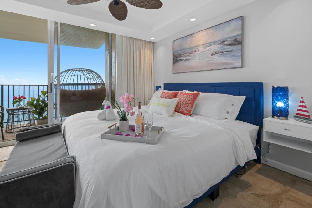 a bedroom with a large bed with a view of the ocean at Sapphire Oasis- Heavenly Ocean View and Resort in Kahana