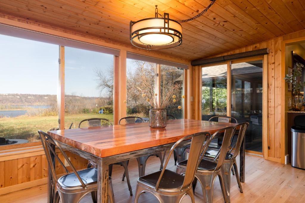 a dining room with a wooden table and chairs at The Lakeview in Red Wing