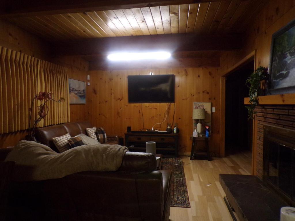 a living room with a couch and a flat screen tv at Ma's Way in Anchorage