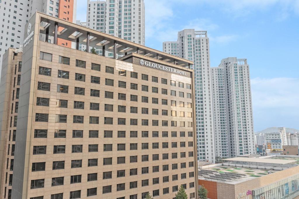 a tall building in a city with tall buildings at Gloucester Hotel Cheongju in Cheongju