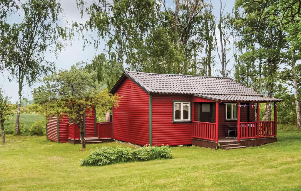 a red tiny house in a grassy field at Awesome Home In Slite With 1 Bedrooms in Gothem