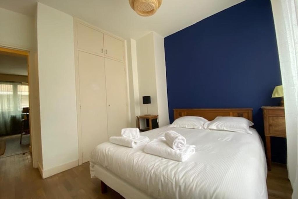 sypialnia z białym łóżkiem i ręcznikami na nim w obiekcie Charming 44m near downtown w Caen