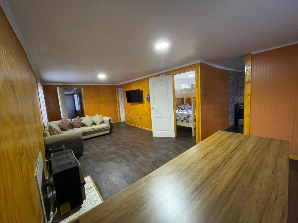 a living room with a couch and a table at Casa en Puerto Natales in Puerto Natales