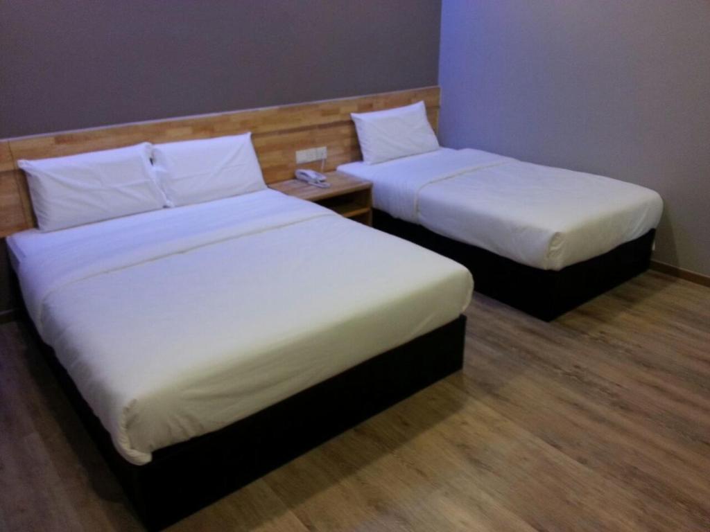 Postel nebo postele na pokoji v ubytování JQ Suria 18 Hotel