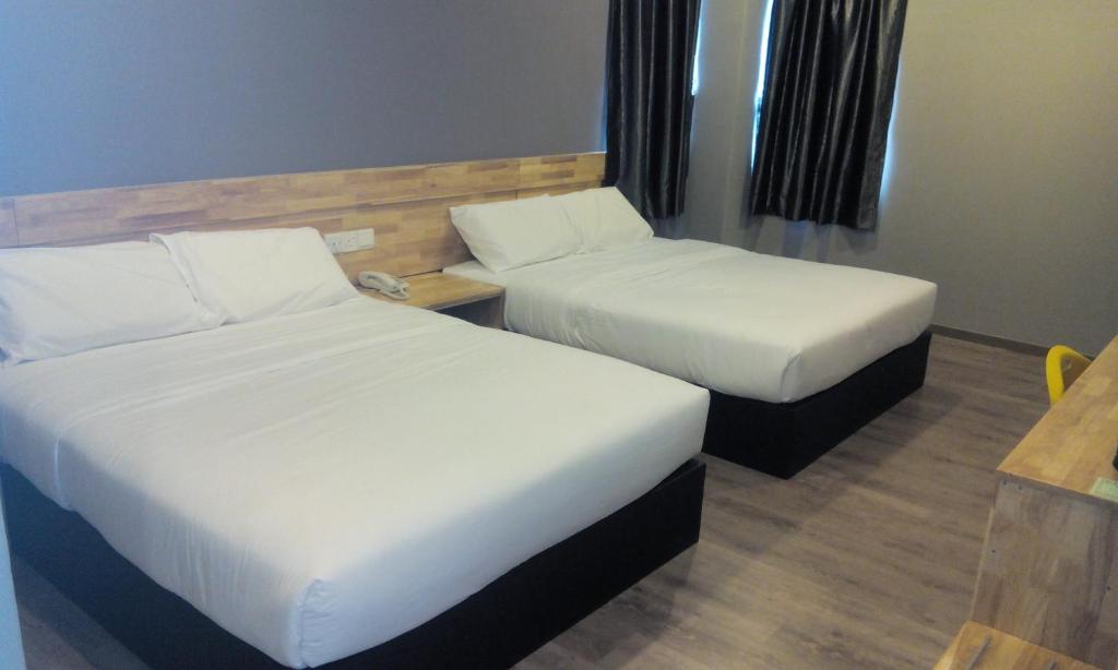 Postel nebo postele na pokoji v ubytování JQ Suria 18 Hotel
