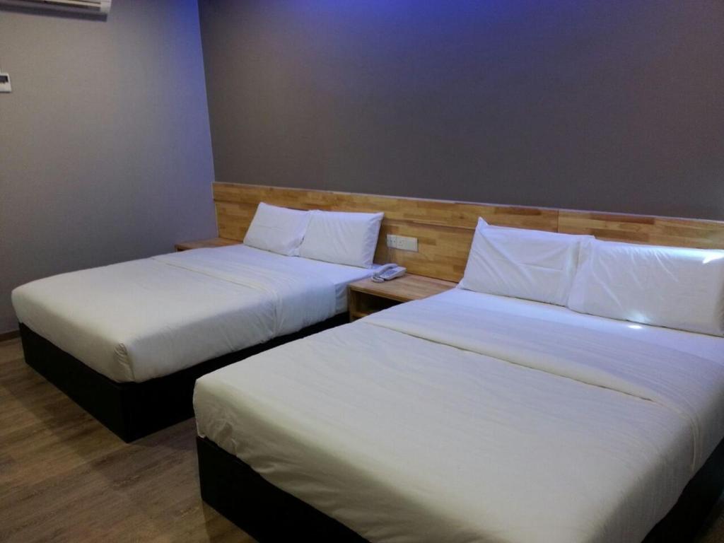 Postel nebo postele na pokoji v ubytování JQ Suria 18 Hotel