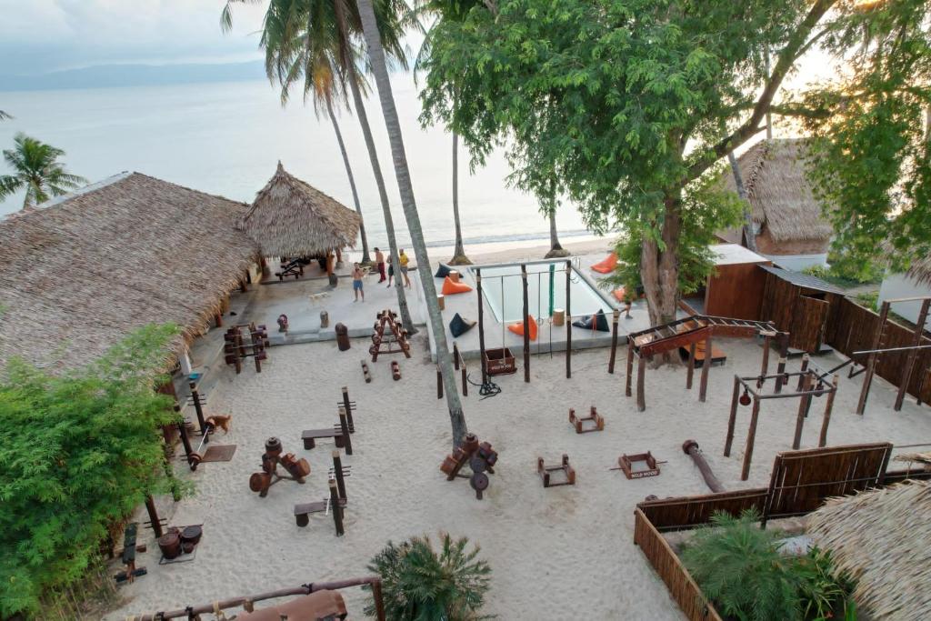 an aerial view of a beach with tables and benches at Wild Wood x Hansa Beach Fitness Resort in Thongsala