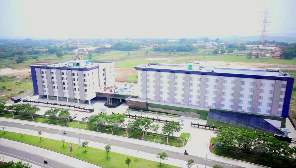 an aerial view of two large buildings and a street at Sakura Park Hotel & Residence in Cikarang