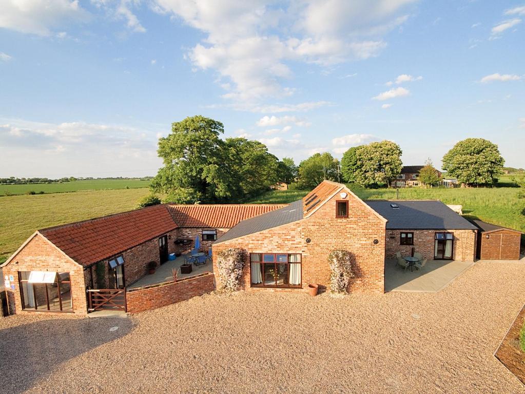 an aerial view of a home with a barn at Plough Cottage in Anderby