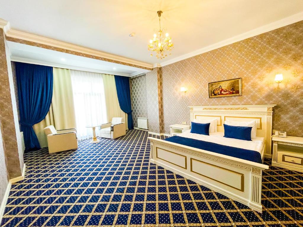 a hotel room with a bed and a chandelier at Premier Palace Baku in Baku