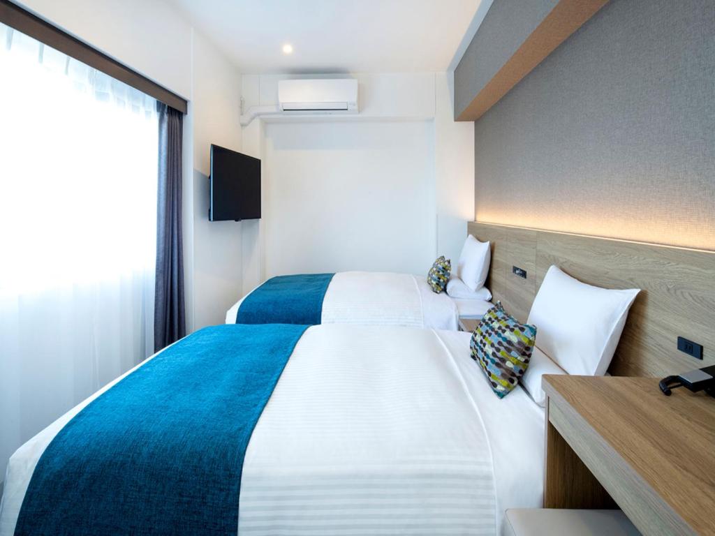 Postel nebo postele na pokoji v ubytování FLEXSTAY INN Shinurayasu