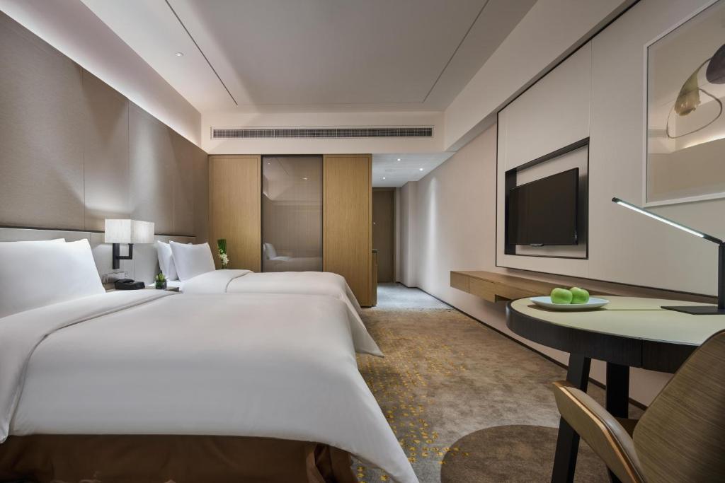 Postel nebo postele na pokoji v ubytování The QUBE Hotel Shanghai Hongqiao