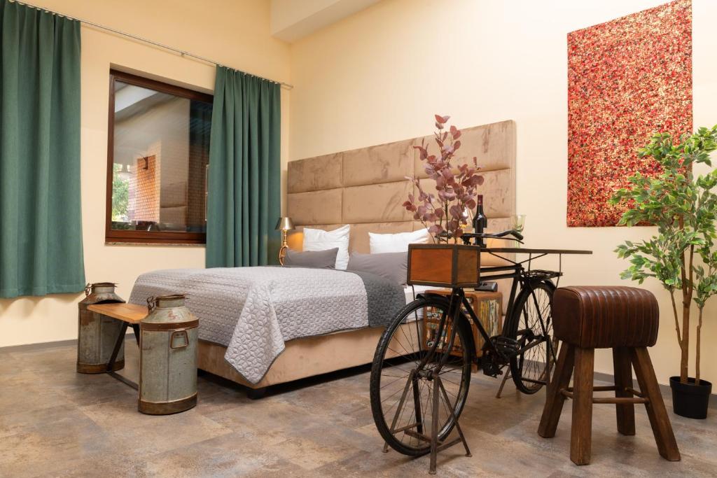 a bedroom with a bed and a bicycle in it at Fabric Apartments in Dettingen an der Erms