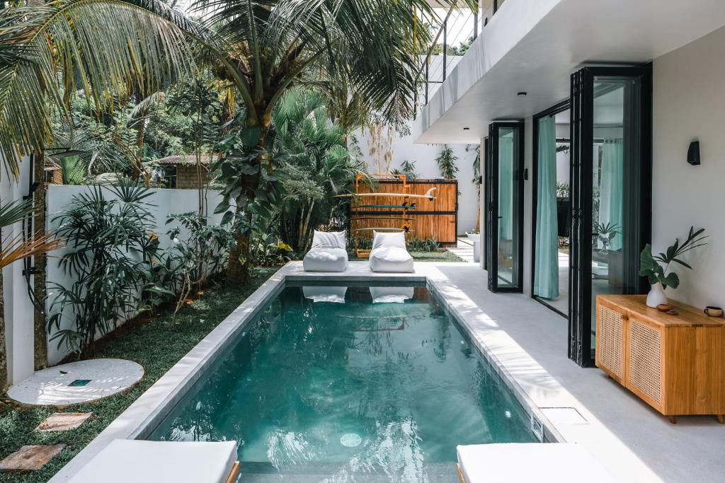 a swimming pool in the middle of a house at Terra Villas in Ahangama