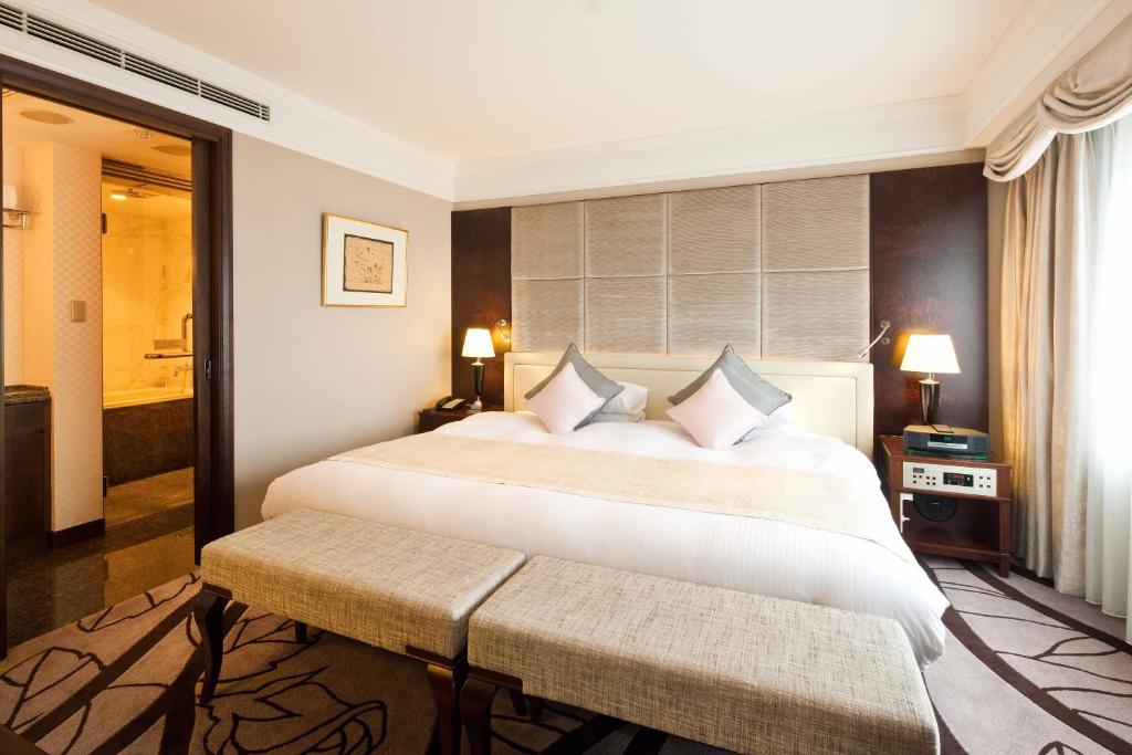 Postel nebo postele na pokoji v ubytování Royal Park Hotel