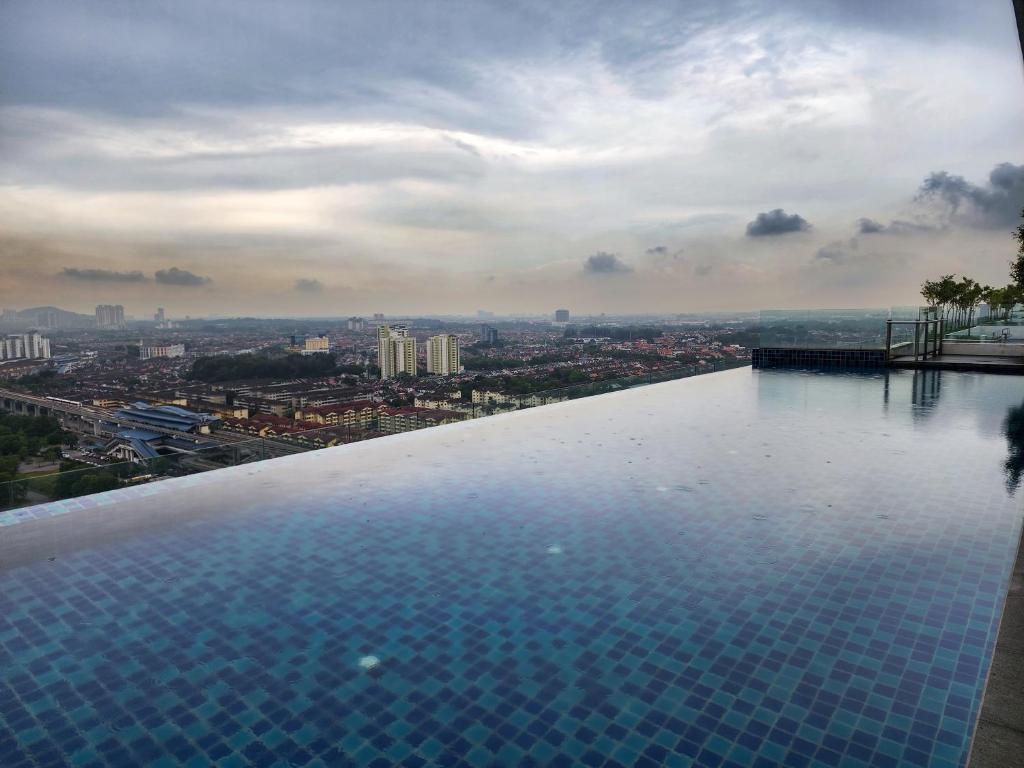a swimming pool with a view of a city at Da Men Space for 2 by Concept A Suites near Sunway Subang in Subang Jaya