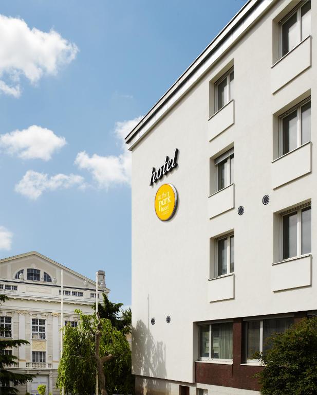 a building with aania logo on the side of it at At the Park Hotel in Baden