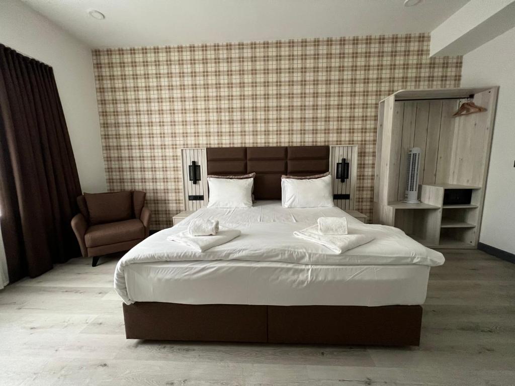 een slaapkamer met een groot bed en een stoel bij Hotel Innception in Keulen