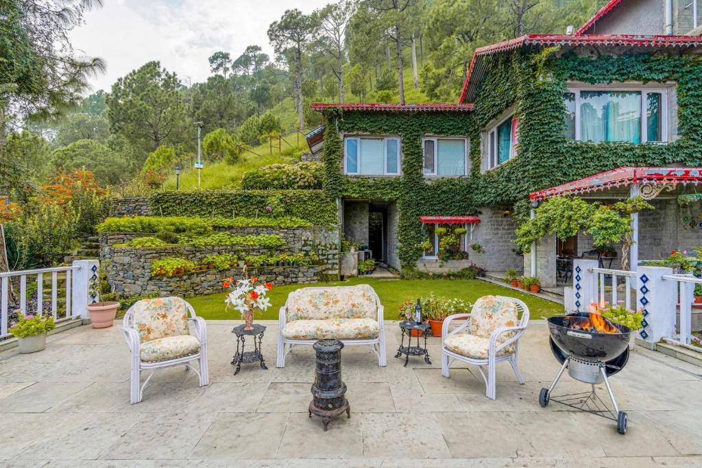 a yard with chairs and a house at StayVista at Destine in Kasauli