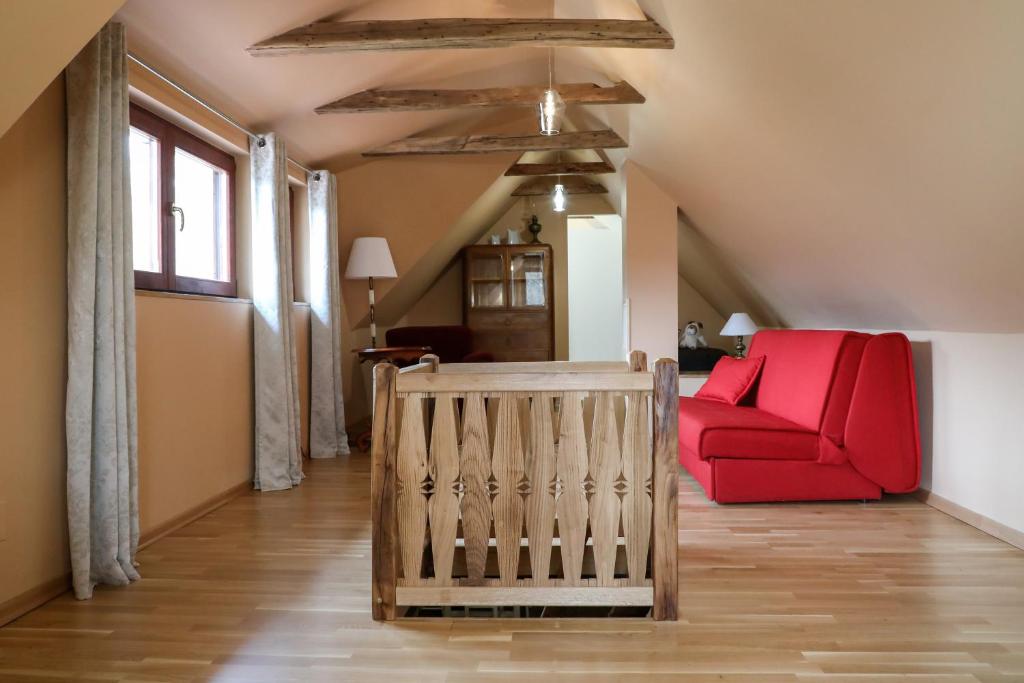 a living room with a red couch and a chair at Country house with a pool in Medvednica Nature Park in Zagreb