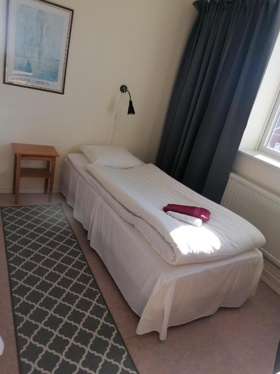 Postel nebo postele na pokoji v ubytování Hotell Hemgården