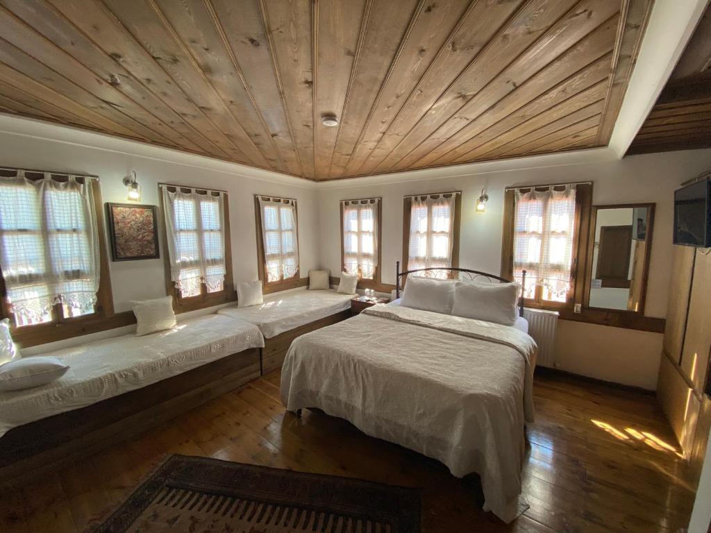 a large room with two beds and windows at Ebrulu Konak in Safranbolu