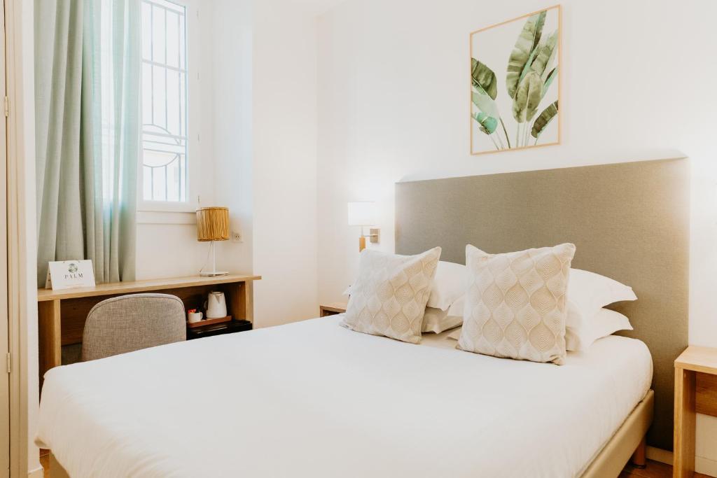 Postel nebo postele na pokoji v ubytování Palm Boutique Hôtel Nice