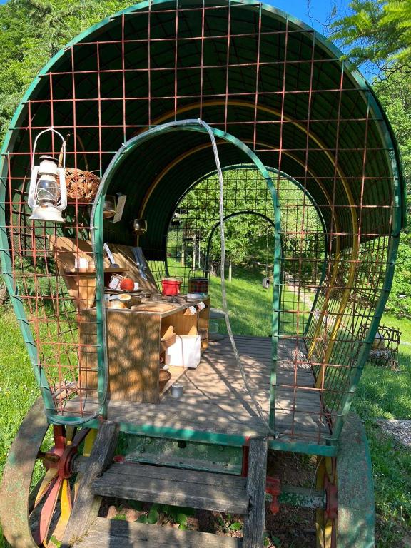 a bird cage sitting on top of a cart at Country house with a pool in Medvednica Nature Park in Zagreb