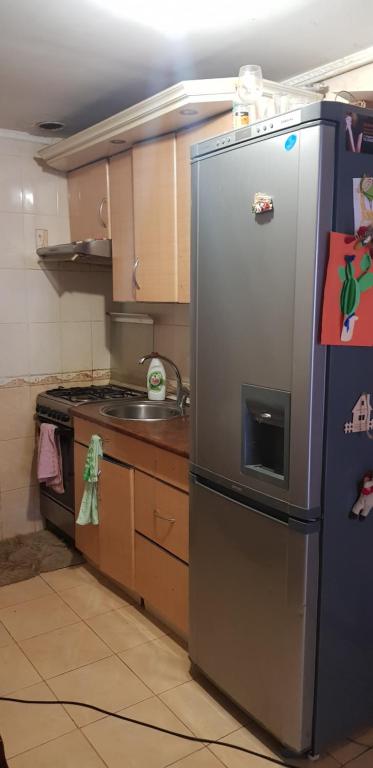 a kitchen with a stainless steel refrigerator and a stove at Magic House in Center in Chişinău