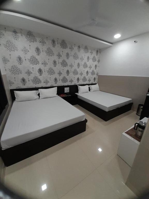 Postel nebo postele na pokoji v ubytování Hotel Shree