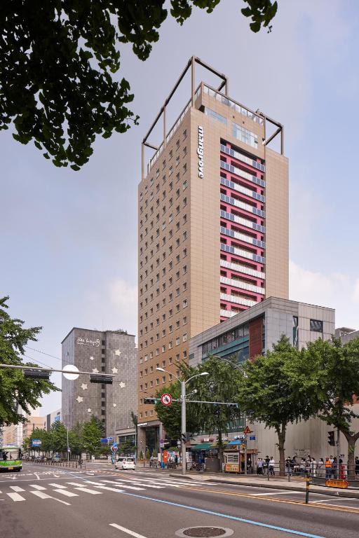 a tall building on the side of a city street at Mangrove Sinseol in Seoul