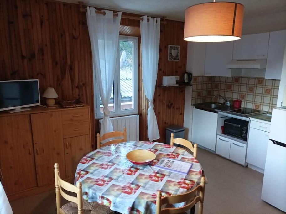 a kitchen with a table with a table cloth on it at 2 pièces proche cure thermale in Roquebillière