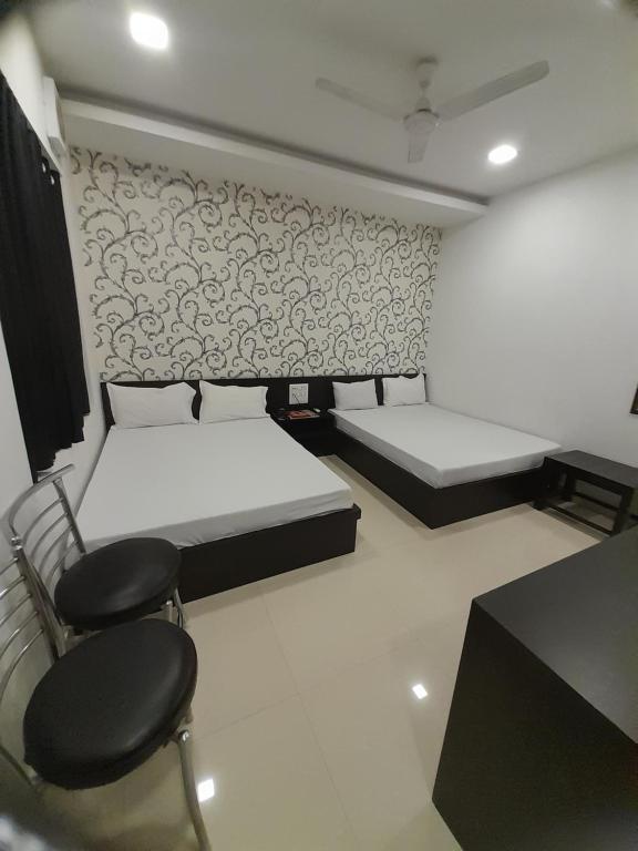 Postel nebo postele na pokoji v ubytování Hotel Shree
