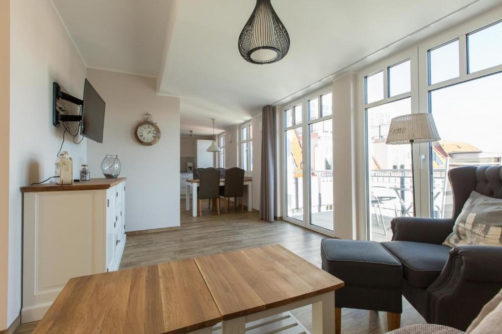 a living room with a couch and a table at Sunnevelt-Apartment-10 in Kühlungsborn