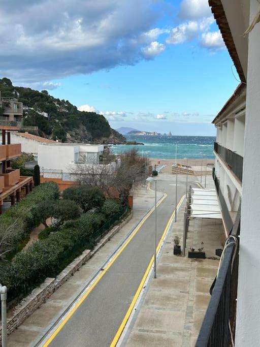 a view of a street with the ocean in the background at La Perla de Sa Riera in Begur